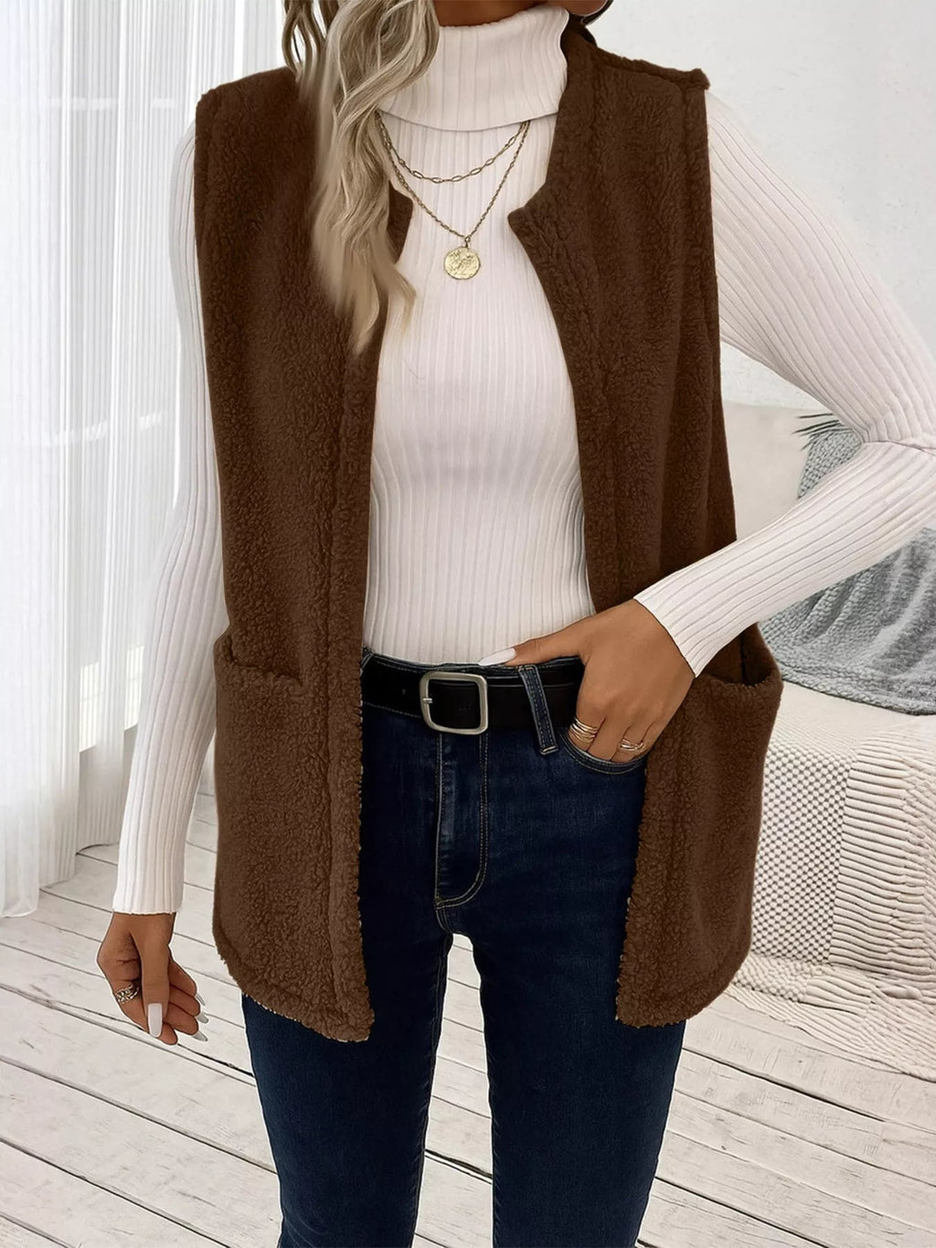 Warm sleeveless fleece vest ideal for layering, offering comfort and versatility in cold weather.