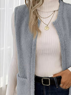 Warm sleeveless fleece vest ideal for layering, offering comfort and versatility in cold weather.