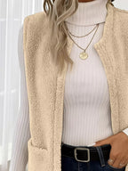 Warm sleeveless fleece vest ideal for layering, offering comfort and versatility in cold weather.