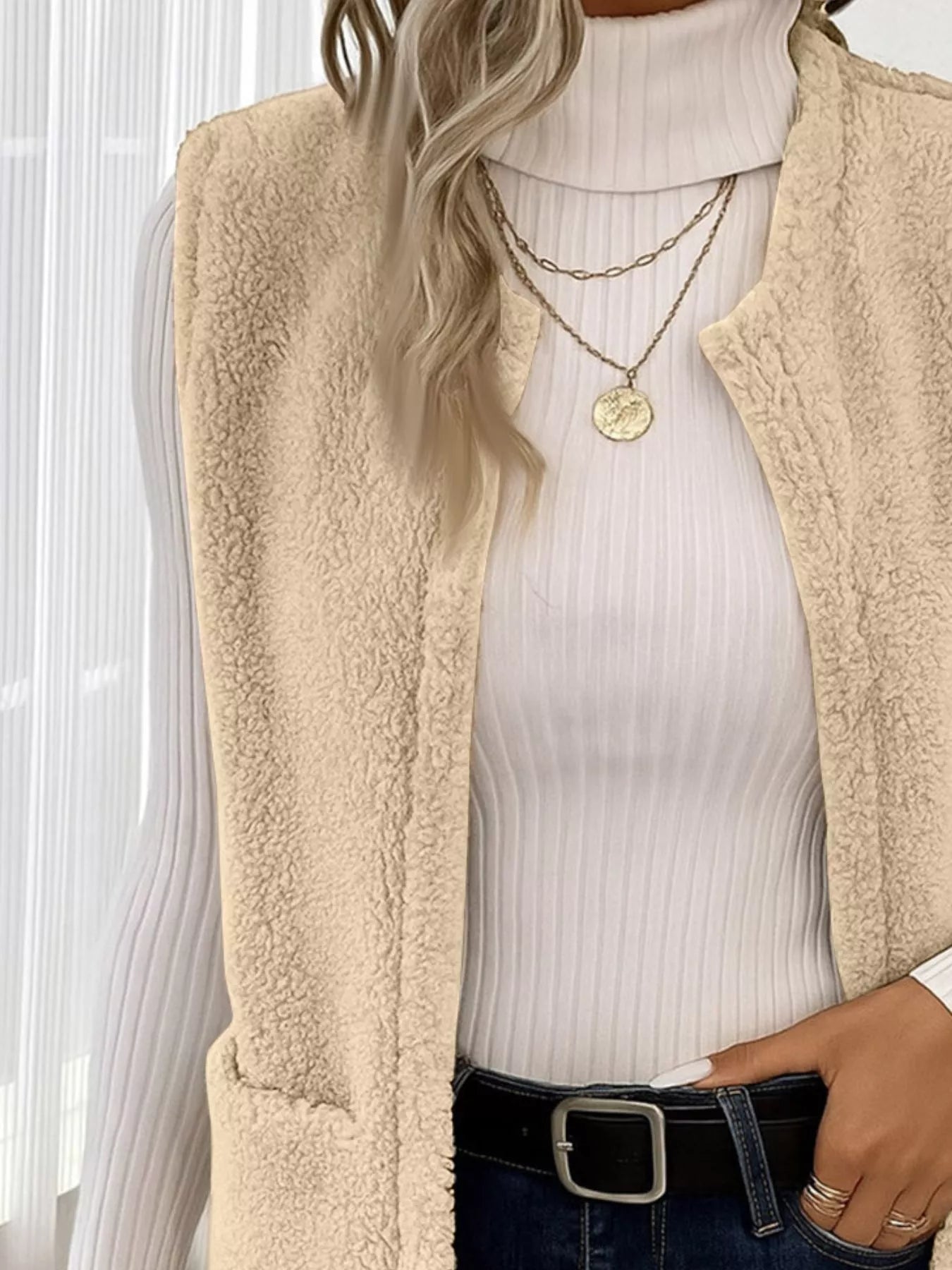 Warm sleeveless fleece vest ideal for layering, offering comfort and versatility in cold weather.