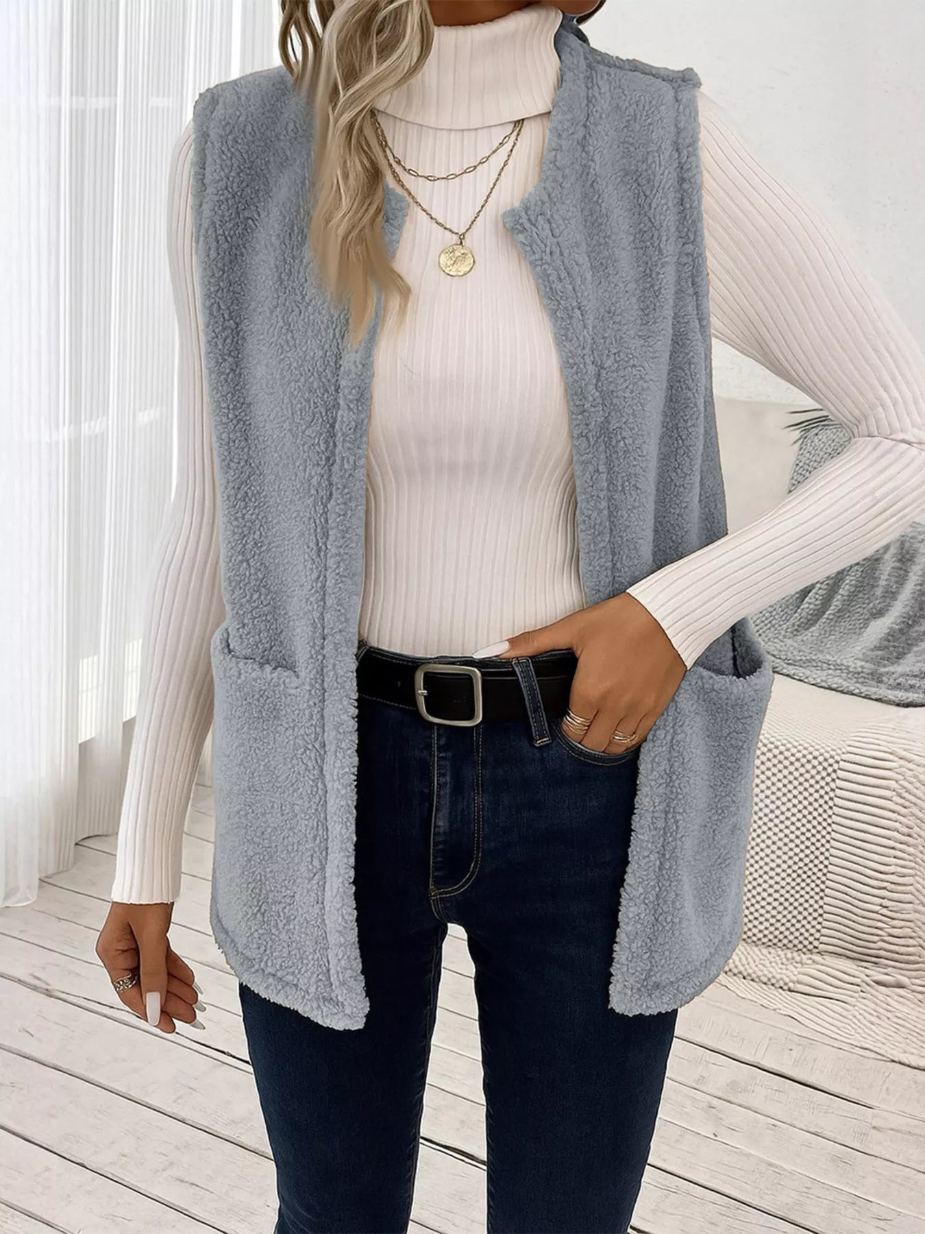 Warm sleeveless fleece vest ideal for layering, offering comfort and versatility in cold weather.