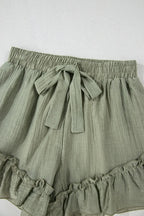 Tie waist shorts with elegant ruffle hem detail, perfect for a stylish and comfortable summer outfit.