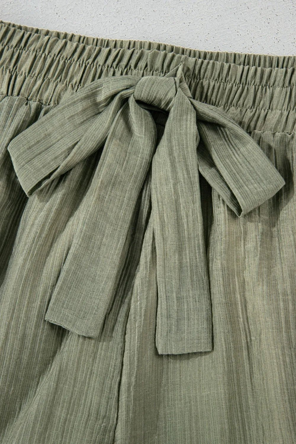 Tie waist shorts with elegant ruffle hem detail, perfect for a stylish and comfortable summer outfit.