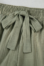 Tie waist shorts with elegant ruffle hem detail, perfect for a stylish and comfortable summer outfit.