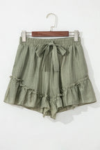 Tie waist shorts with elegant ruffle hem detail, perfect for a stylish and comfortable summer outfit.