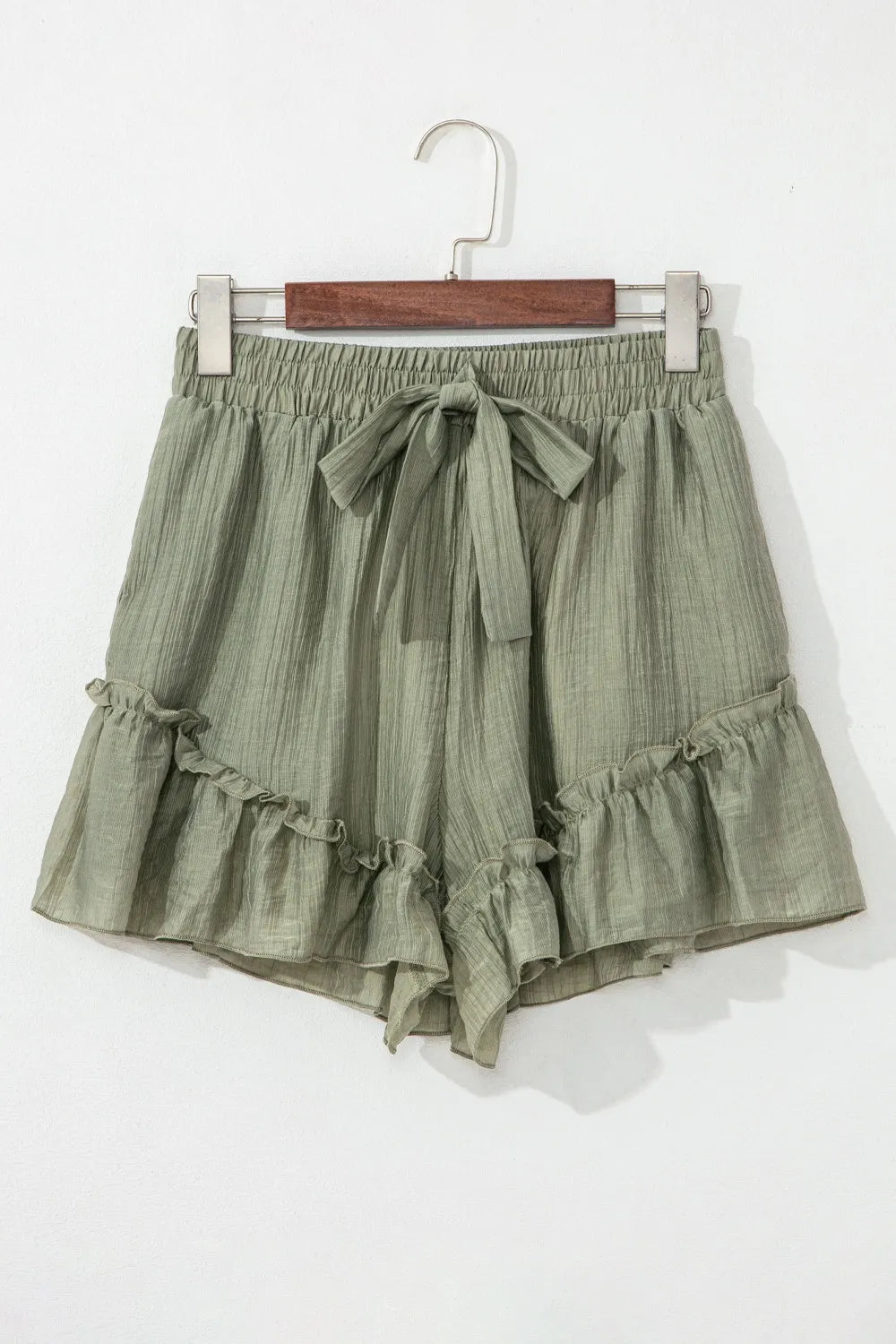 Tie waist shorts with elegant ruffle hem detail, perfect for a stylish and comfortable summer outfit.