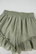 Tie waist shorts with elegant ruffle hem detail, perfect for a stylish and comfortable summer outfit.