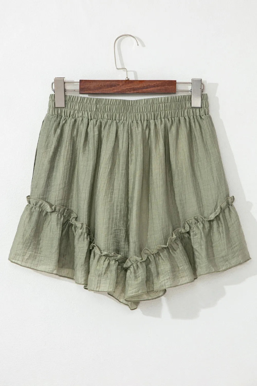 Tie waist shorts with elegant ruffle hem detail, perfect for a stylish and comfortable summer outfit.
