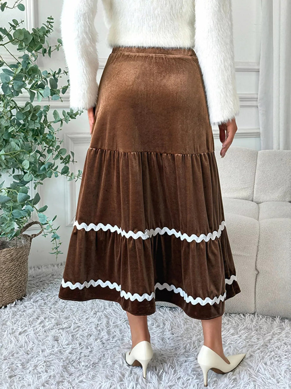 Elegant velvet midi skirt in rich texture, perfect for sophisticated occasions and stylish wardrobe essentials.