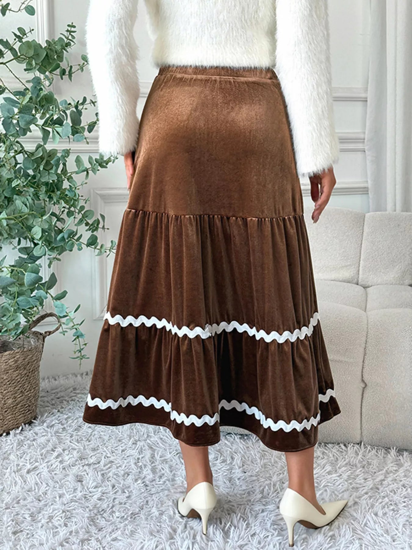 Elegant velvet midi skirt in rich texture, perfect for sophisticated occasions and stylish wardrobe essentials.