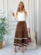 Elegant velvet midi skirt in rich texture, perfect for sophisticated occasions and stylish wardrobe essentials.